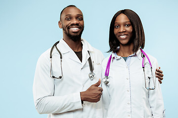 Image showing The female and male happy afro american doctors on blue background