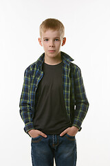 Image showing Portrait of a boy of ten years in a plaid shirt and jeans