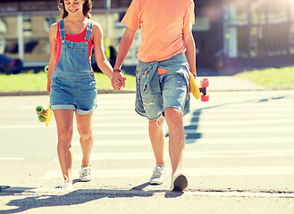 Image showing teenage couple with skateboards at city crosswalk