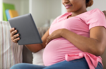 Image showing happy pregnant woman with tablet computer at home