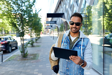 Image showing man with tablet pc and backpack on city street