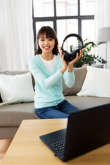 Image showing female blogger with headphones making video blog