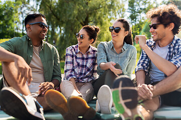 Image showing friends hanging out and talking outdoors in summer