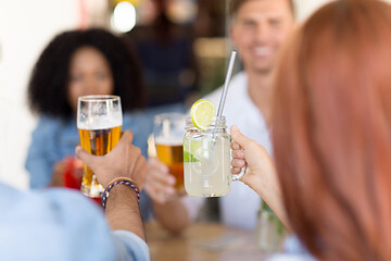 Image showing friends clinking glasses at bar or restaurant