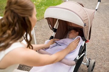 Image showing mother with child in stroller at summer park