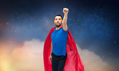 Image showing man in red superhero cape over night sky