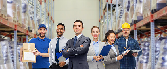 Image showing group of business people and warehouse workers