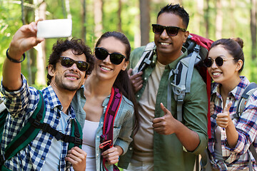 Image showing friends with backpacks hiking and taking selfie