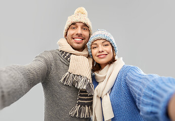 Image showing happy couple in winter clothes taking selfie