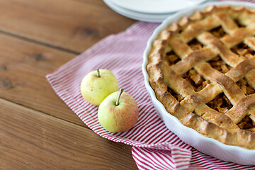 Image showing apple pie in baking mold on wooden table