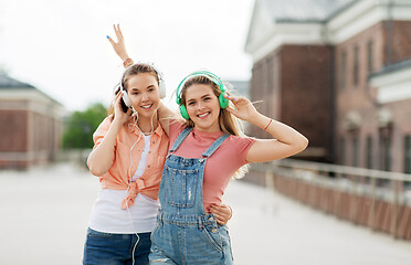 Image showing teenage girls or friends in headphones in city