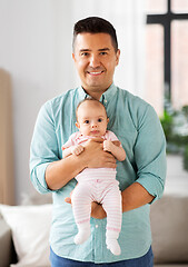 Image showing middle aged father with baby daughter at home