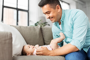 Image showing middle aged father playing with baby at home