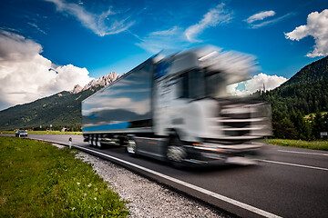 Image showing Fuel truck rushes down the highway in the background the Alps. T