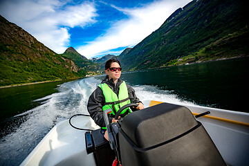 Image showing Woman driving a motor boat