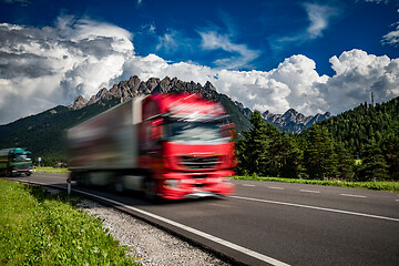 Image showing Fuel truck rushes down the highway in the background the Alps. T