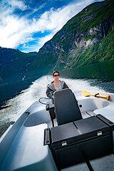 Image showing Woman driving a motor boat