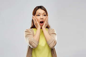 Image showing scared asian woman over grey background