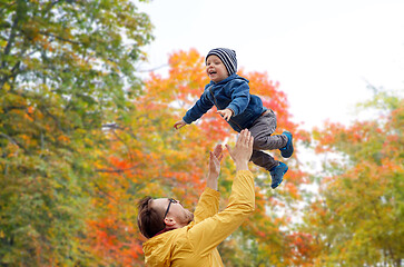 Image showing father with son playing and having fun in autumn