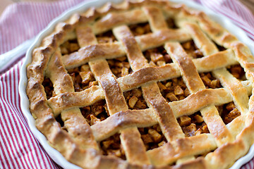 Image showing close up of apple pie in baking mold on towel