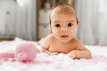 Image showing sweet baby girl lying on knitted plush blanket