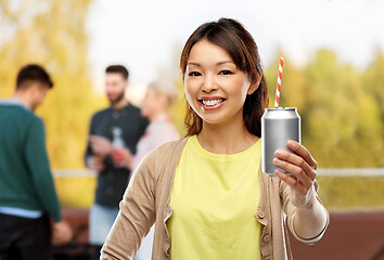 Image showing asian woman with can drink over rooftop party