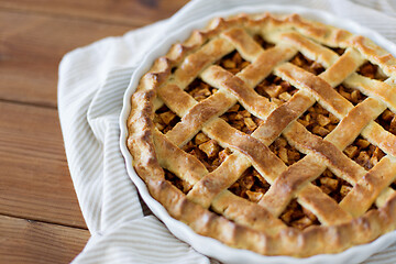 Image showing close up of apple pie in mold on wooden table