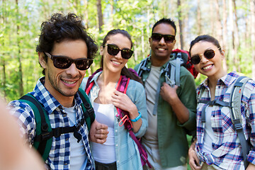 Image showing friends with backpacks hiking and taking selfie