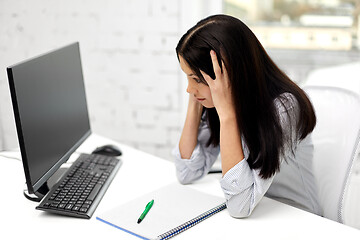 Image showing stressed businesswoman with computer at office