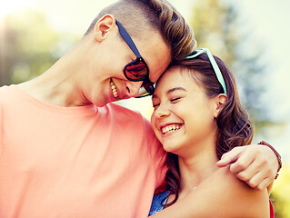 Image showing happy teenage couple hugging at summer