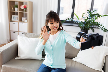 Image showing asian female blogger with camera recording video