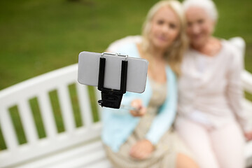 Image showing daughter and senior mother taking selfie at park