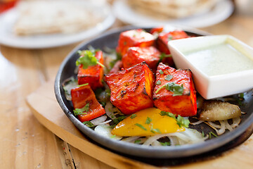 Image showing close up of paneer tikka dish with sauce on table