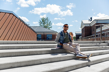 Image showing man in headphones listening to music on roof top