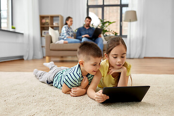 Image showing brother and sister with tablet computer at home