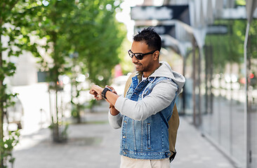 Image showing indian man with smart watch and backpack in city