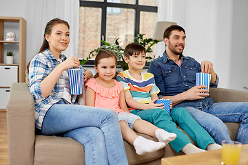 Image showing happy family with popcorn watching tv at home