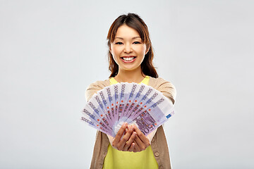 Image showing asian woman with hundreds of euro money banknotes