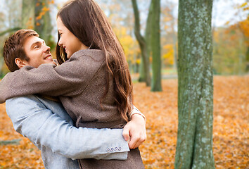 Image showing smiling couple hugging in autumn park