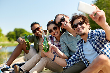 Image showing friends with drinks taking selfie by smartphone