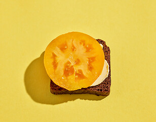 Image showing bread with butter and yellow tomato