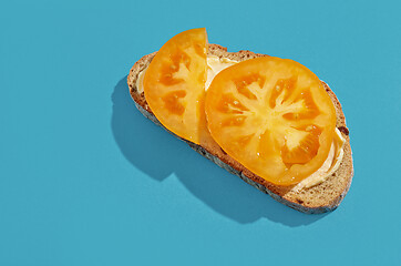 Image showing slice of bread with yellow tomato