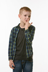 Image showing Boy picking fingers in nose isolated on white background