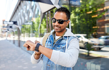 Image showing indian man with smart watch and backpack in city