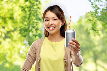 Image showing asian woman with can drink over natural background