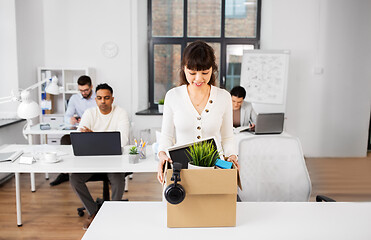 Image showing happy businesswoman with personal stuff at office