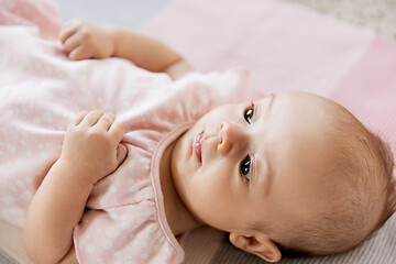 Image showing sweet baby girl lying on knitted blanket