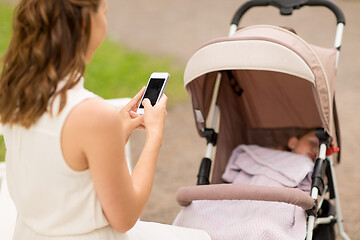 Image showing mother with smartphone and baby in stroller