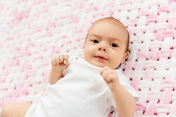 Image showing sweet baby girl lying on knitted plush blanket