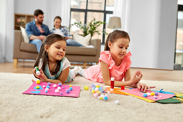 Image showing happy sisters doing arts and crafts at home